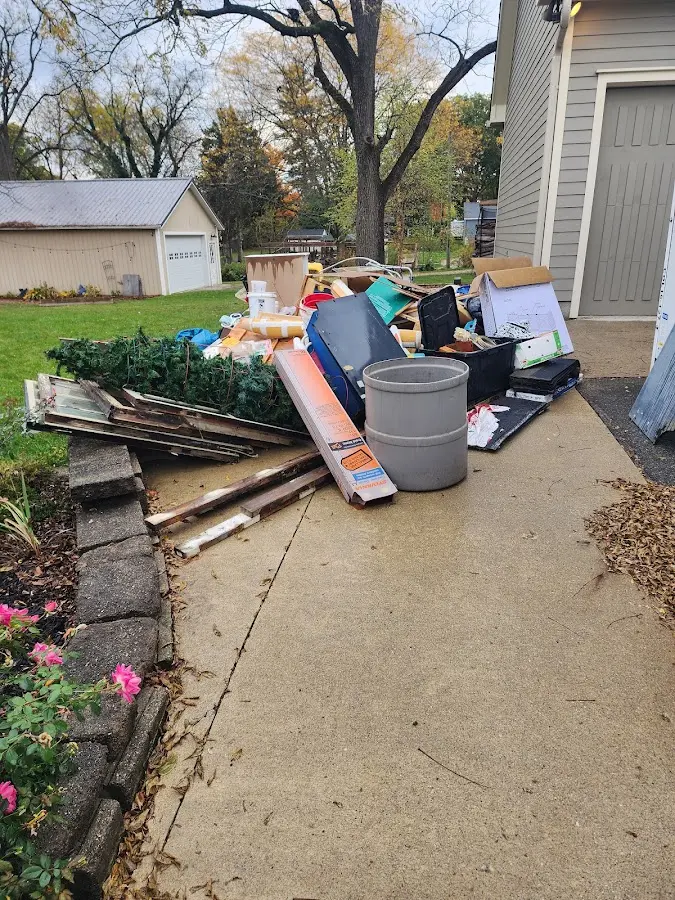 Dumpster being loaded with debris for 3 Yard Dumpster Rental in Alton